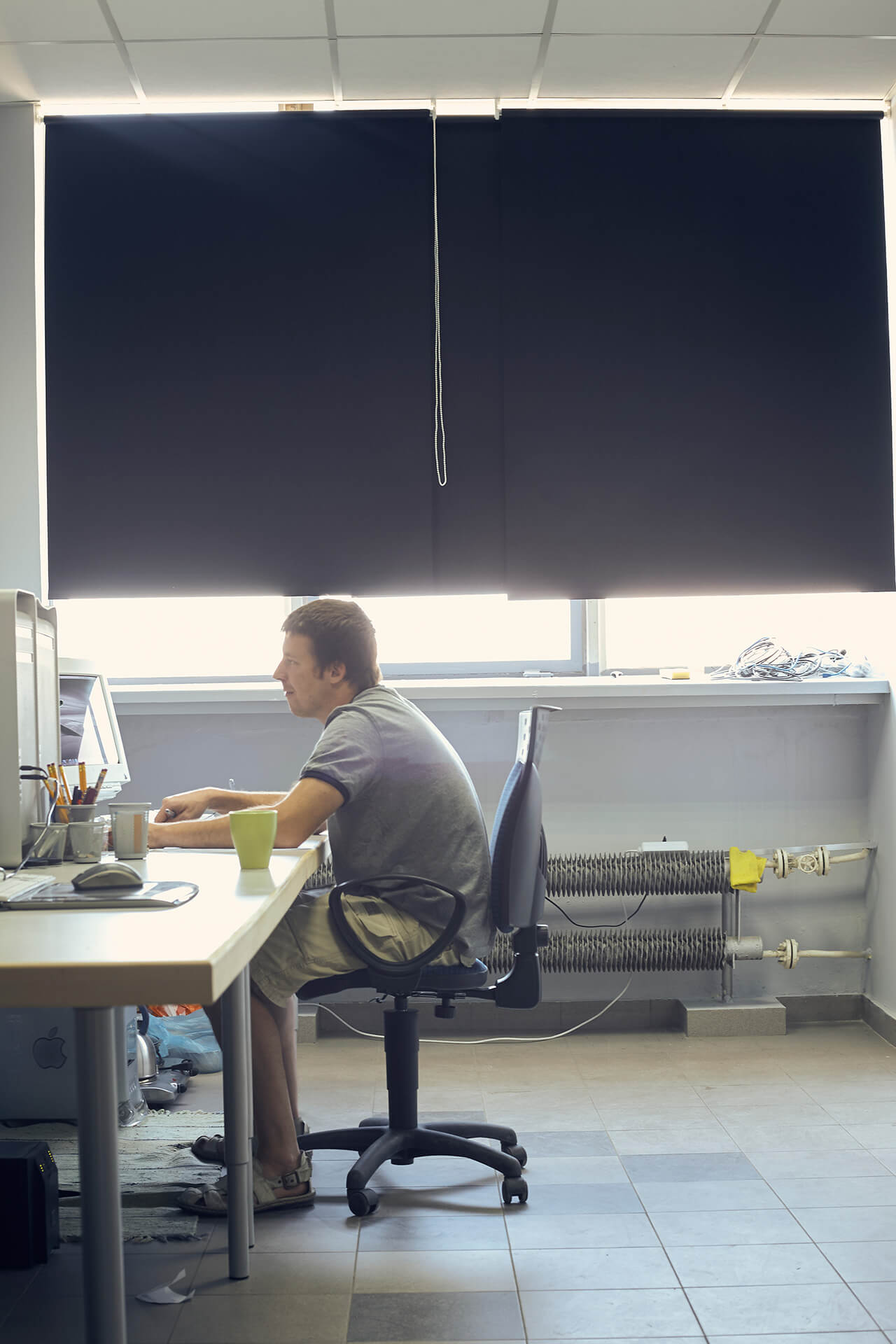 Krzysztof Gadomski working at his desk in the first House of Retouching studio in 2008.